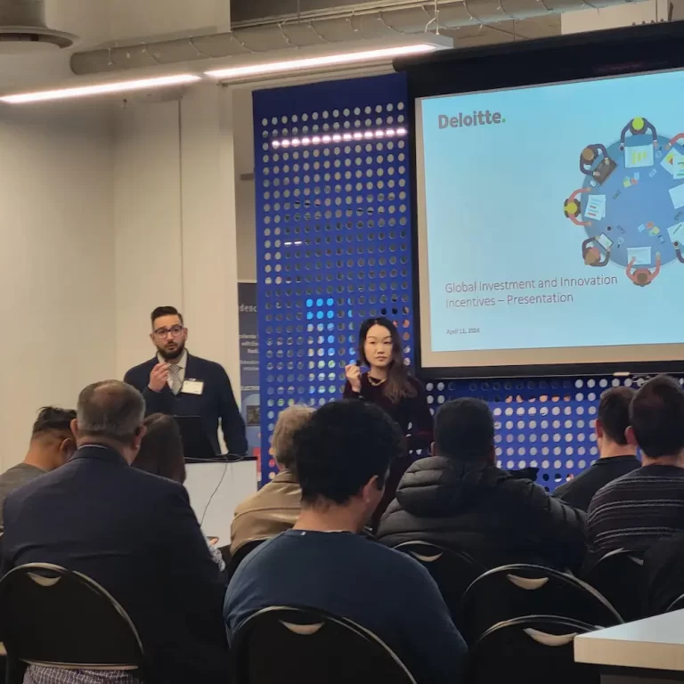 man and woman presenting in front of crowd