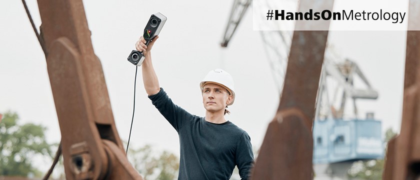 man with hand held 3d scanner