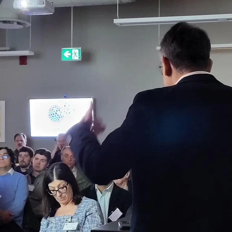 Man presenting in front of a crowd