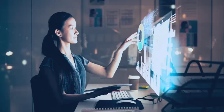 woman working at desk interacting with computer